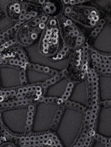 Timeless black appliquéd clutch with sequins, includes a shoulder chain and clasp closure, perfect for holding a smartphone.