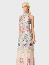 A floral gown featuring a vibrant floral print fabric, showcasing a blend of colors and patterns.
