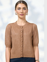 A woman wearing a brown cardigan sweater, standing confidently with a neutral background.
