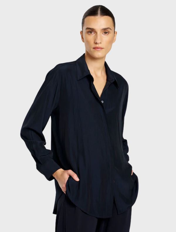 A model is seen wearing a navy shirt and pants, exemplifying a polished and cohesive style.