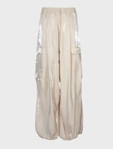  Cream pants with liquid-like shine, elastic waistband, and voluminous legs for a modern, stylish look.