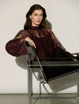 Scalloped lace trapeze top in elderberry with stand collar, keyhole back, and flounce cuffs for a refined silhouette.