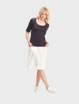 White Acrobat Legion skirt displayed on a hanger, showcasing its sleek design and fabric texture.