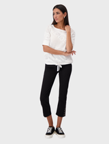 Elegant cream sweater featuring a round neck and ajour pattern, perfect for layering in cooler weather.