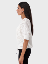 Lightweight cream sweater with a round neckline and ajour design, offering a chic and comfortable fit.