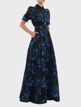 Navy Alexandra Gown featuring a floral design in black and blue with short sleeves.