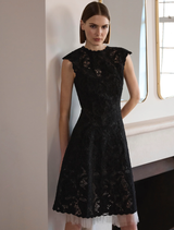 Black Alexandria dress displayed on a mannequin, featuring a fitted silhouette and elegant design.