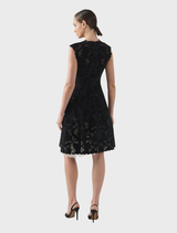 Black Alexandria dress draped on a hanger, emphasizing its modern design and versatile appeal.