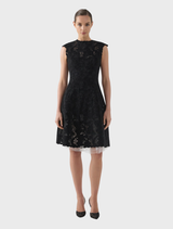 Black Alexandria dress showcased on a model, illustrating its stylish cut and contemporary fashion.