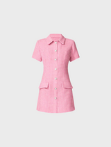displays a pink shirt dress, complete with button accents.