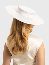 Elegant white boater hat featuring minimalist ribbon trim and a fitted headband, perfect for Derby Day or stylish occasions.