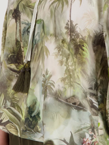Stylish olive blouse with a tropical print, round neckline, and ¾ sleeves, crafted from 100% viscose for summer comfort.