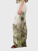 Summer-ready olive palazzo pants featuring a tropical design, crafted from light fabric with a satin appearance.
