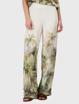Olive tropical print palazzo pants made from lightweight fabric with an elegant satin finish, perfect for summer wear.