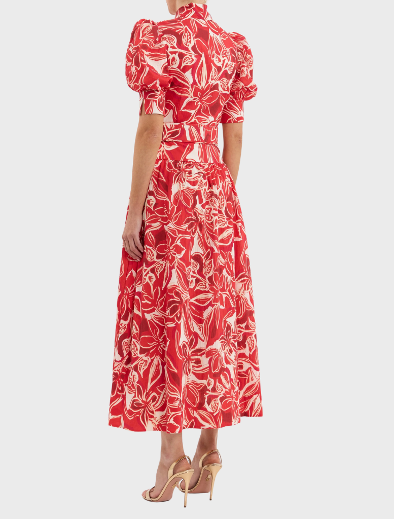 A red dress with an elegant floral print in contrasting white and red colors.