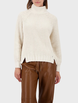 Soft almond chenille sweater draped elegantly, highlighting its plush fabric and relaxed fit.