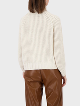 Almond-hued chenille sweater laid out, featuring a soft texture and comfortable design ideal for casual wear.