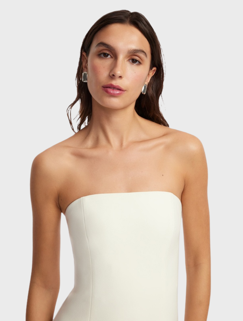 Graceful vanilla maxi dress with an intricate appliqué bustier, designed for elegance at any formal gathering.