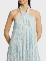 The Luana Dress in aqua, showcasing a soft fabric and stylish cut, elegantly draped on a hanger.