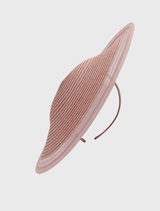 Chic blush pink fascinator on a headband, designed with sheer edges, suitable for fashion events and race days.