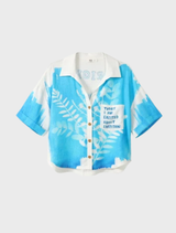 Indigo linen cropped shirt adorned with white botanical patterns, featuring a classic collar and a relaxed, stylish fit.