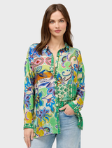 The Audrey Tunic features an Armeria Patchwork design, combining various colors and patterns for a trendy, eye-catching style.