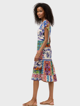 Elegant tea-length dress with a tiered design, complemented by a floral Armeria scarf for a chic, sophisticated look.