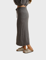 Ash Merino cotton pleat skirt, showcasing a refined silhouette perfect for both casual and dressy outfits.