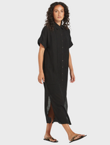 Linen black shirt dress draped elegantly, emphasizing its breathable fabric and classic style.