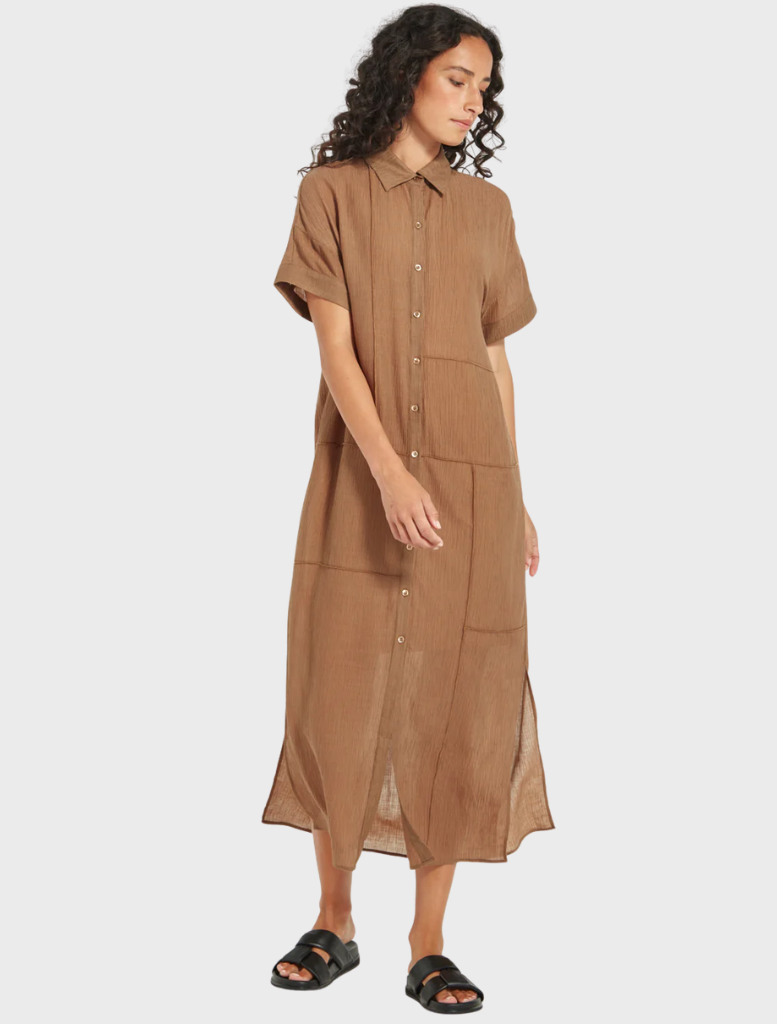 Side view of woman wearing Aubrey Dress in bark, brown button-front midi dress with short sleeves from Mariko Boutique