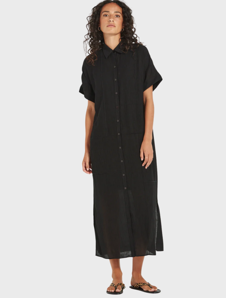 Black linen shirt dress displayed on a hanger, showcasing its lightweight fabric and elegant design.