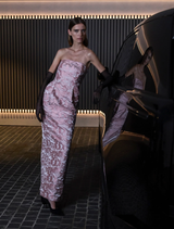 Strapless gown in two-tone pink floral jacquard, featuring a fitted bodice, elongated pencil silhouette, and subtle pockets.
