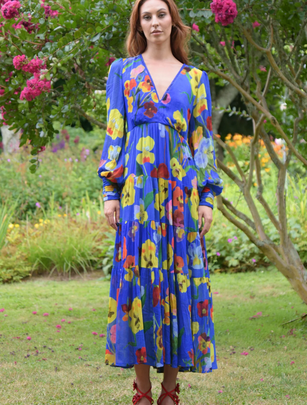 Vintage floral dress with a blue trim, showcasing a vibrant floral print, perfect for a stylish summer look.