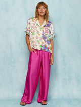 Aya shirt featuring motivational "THINK positive" text, large purple flowers, and colorful floral patterns on one side.