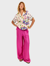 Aya shirt with "THINK positive" text in pink, adorned with large purple flowers and scattered pink florals and sunbursts.