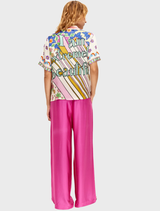 Knit collar shirt showcasing "THINK positive" in pink, large purple flowers, and scattered pink and orange floral accents.
