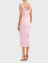 A pink dress with a v-neck and strap design, offering a trendy and feminine silhouette.