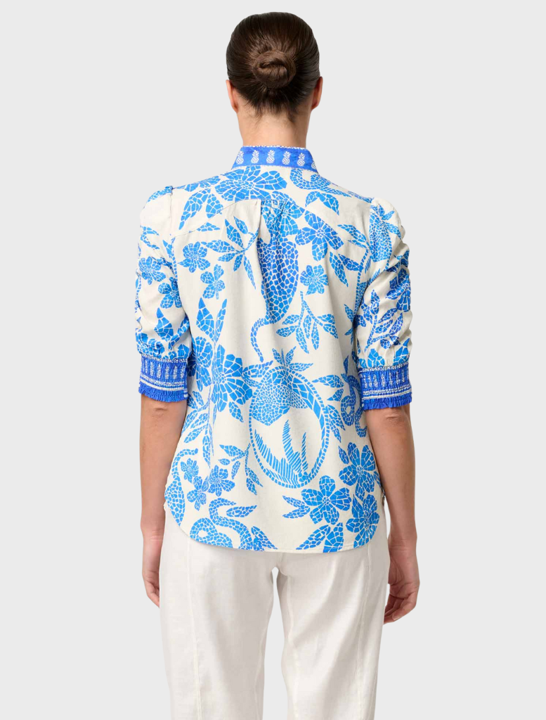 Back view of a woman in a blue and white floral shirt, showcasing the Calantha Viscose Dobby Rouched Sleeve design.