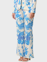 A woman in a blue and white floral suit, highlighting the Azure Mosaic pattern of the Leandro Contrast Lace Linen Viscose Stretch Pant.