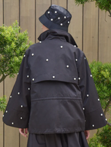 Close-up of the black Baby I'm Back Jacket, focusing on the fabric and stitching for a detailed look.