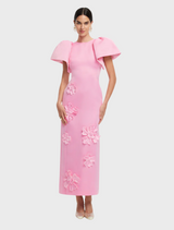 A pink dress adorned with a delicate floral pattern, highlighting its elegant and feminine style.