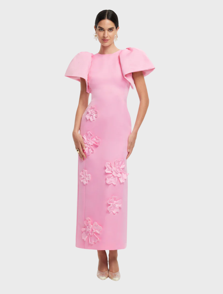 A pink dress adorned with a delicate floral pattern, highlighting its elegant and feminine style.
