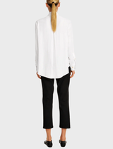Stylish white blouse with a balcony design and lace accents, suitable for warm weather wear.