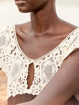 Timeless long dress in black and white with a flowing design, featuring an ecru lace bib for a refined, romantic look.