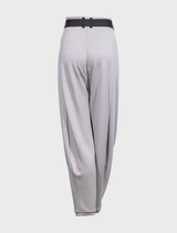 Opal barrel trousers laid flat, showcasing their modern cut and soft fabric in a light, neutral tone.