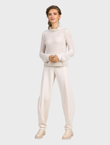 Stylish vanilla barrel trousers laid flat, highlighting their tapered legs and soft fabric texture.