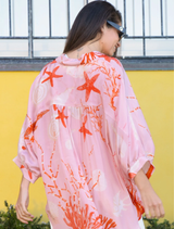 Elegant pink shell shirt with a fashionable open back, combining comfort and style for a chic appearance.