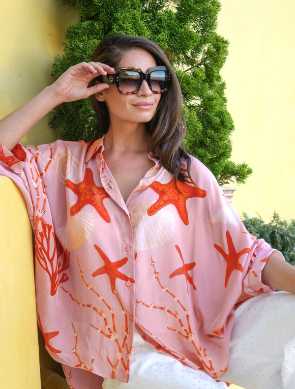 Pink shell shirt with a unique design featuring an open back, perfect for a stylish and trendy look.