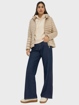 Beige Bern quilted jacket displayed on a hanger, showcasing its textured fabric and stylish design.