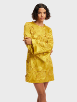 Mini dress with opulent embellishments and dramatic bell sleeves, combining elegance and modern fashion.
